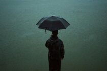 man holding an umbrella in rain image by abhishek sanga for scottshak's poem